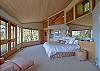 The spacious master bedroom opens to the decks and the view.