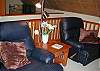 There is a seating area in the loft where one can rest, read, or take in the views through the wall of windows.