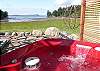 Gaze due south, over Buck Bay, while soaking in the hot tub at Paris Cottage.