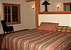 The master suite offers a king size bed, high cathedral ceilings and private tiled bath with soaking tub and separate shower.