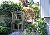 This home has lovely plantings of lavender, rhododendrons and shrubs for guests to enjoy while taking a stroll through the grounds. Beyond the gate is the deck of the detached guest house.