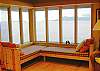Two day beds have a view of Sinclair Island. Bedding for overflow guests is provided for the windowseats.