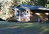 Separate cottage has a double bed, bathroom & looks across the sloped yard to the water