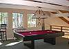 A pool table is located in the game room on the loft.