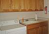 The convenient utility room, just off the garage, will provide you with ample changing room after a family beach visit.