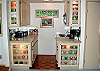 The guest house has a convenience kitchen with cabinets that display colorful glassware.