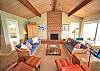 Cozy living room with TV, fireplace, and game table.