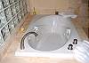 Jetted soaking tub and separate shower stall in the master bath.