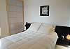 A shoji screen provides privacy for the lower level bedroom with queen size bed.