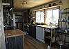 Well equipped kitchen with open displays.