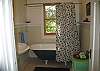 This bathroom is situated between the three upper bedrooms. Enjoy the clawfoot tub after a day spent combing the local beaches.