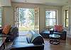 The lower level offers a seating area, entertainment center, fireplace, and doors to the lawn.