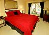 This queen size bedroom opens to the patio with the hot tub and sauna.