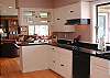 The kitchen looks through to the dining area and living room.
