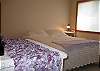 Two bedrooms are located on the second story. One of these bedrooms offers a queen size bed.