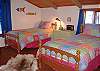 Twin beds are located on the waterview side of the loft. A partition separates this area from the double bed.