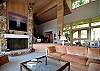 This gorgeous living room features a wood burning fireplace and baby grand in the entry.