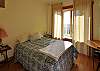 This sunny master bedroom has views over Lopez Village and to the waterfront in the distance.