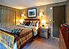 The master bedroom offers a queen bed private bath,  and views of Neil Bay through double doors that open offering easy access to deck and hot tub.
