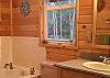 The three top floor bedrooms share this entry level bath with a hand shower.