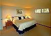This cheerful king-bed room on the lower level has a view to the water and a patio.