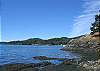 The view south-west toward Doe Bay is of the rocky beach at low tide.