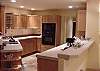 Fully equipped kitchen has decorator tile accents and nice appliances including a convex micro oven.