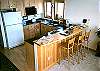 The compact kitchen features a breakfast bar.