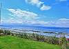 Lawn leads to the bulkhead and beachfront beyond.