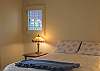 The guest bedroom offers a queen size bed and opens into the back yard &amp; patio.