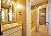 Lower level baths are two powder rooms connected by a shared tub/shower.