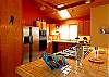 The kitchen features tiled surfaces and stainless steel appliances.