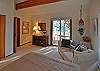 The master offers a seating area and door to the deck.