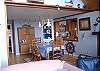 There are six chairs for use at the dining table. The dining area is decorated with nautical whimsy.