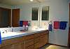 Master bedroom bath has a large vanity with two sinks.