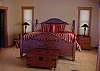 Upper level master bedroom with king bed, private bath, and loft seating.
