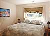 Lower level bedroom with king bed adjoins living area & bath.