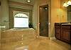 Master bath has dual vanity, stallshower, soaking tub, toilet compartment, and his/her walk-in closets.