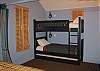 Custom bunk beds in the Paddock offerthree berths (including the trundle bed) with custom closet and lighting at bedside for reading.