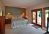 The master bedroom is on the lower level and opens to the deck with the hot tub.