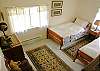 A third bedroom contains two twin beds.