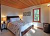 The spacious master bedroom features embroidered linens.