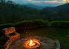 Firepit with view of mountains at dusk. 