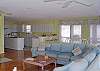 The open kitchen, Dining room, and Living room can easily accomodate all.  The deck is accesible from this area.