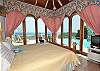 Both bedrooms have full glass walls on two sides to maximize the spectacular view. The arched French doors along both walls can close as screen doors, or as glass doors to use the air conditioner.