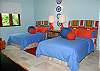Caribbean blues and starfish art create a magical room for the young or young at heart. This bedroom features two double beds and a private bathroom along with a flat screen TV and DVD player.