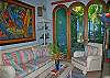 Eclectic, fun touches are everywhere, from the colorful laughing sprite in the corner, to the whimsical lamps.