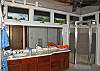 Both bathrooms in the main house are spacious and have an open airy feel. One has bath/shower combination, and this one has a glass shower enclosure. In an adjacent hallway is a closeted washer/dryer for guest use at Maison Meile.