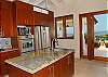 A fully outfitted gourmet chef's kitchen fitted with solid mahoghany cabinets, European hardware, Caribbean blue glass tiles and rare artisan onyx counter tops.
