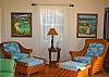 Back inside, comfortable lounge seating is provided for enjoying movie nights in front of the TV, or a quiet area for reading. The entertainment center is conveniently located in a gorgeous armoire.